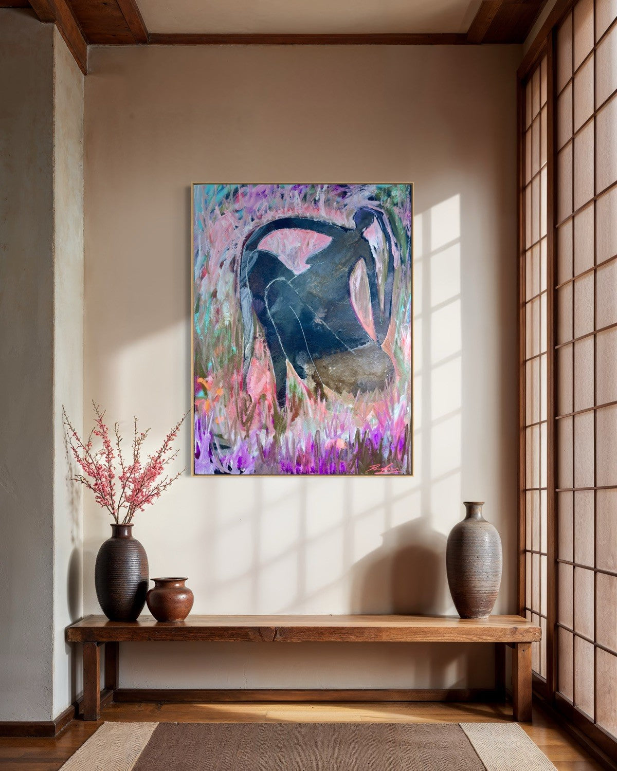 A framed abstract painting featuring a dark blue silhouette against a vibrant purple, pink, and teal background, displayed on a beige wall in a traditional Japanese-style room with a wooden bench and shoji screen.
