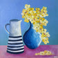 Painting of a blue vase with yellow flowers and a striped pitcher on a pink surface against a blue background.