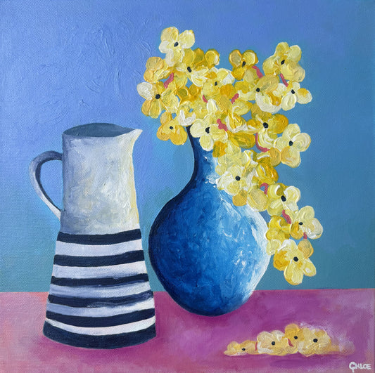 Painting of a blue vase with yellow flowers and a striped pitcher on a pink surface against a blue background.