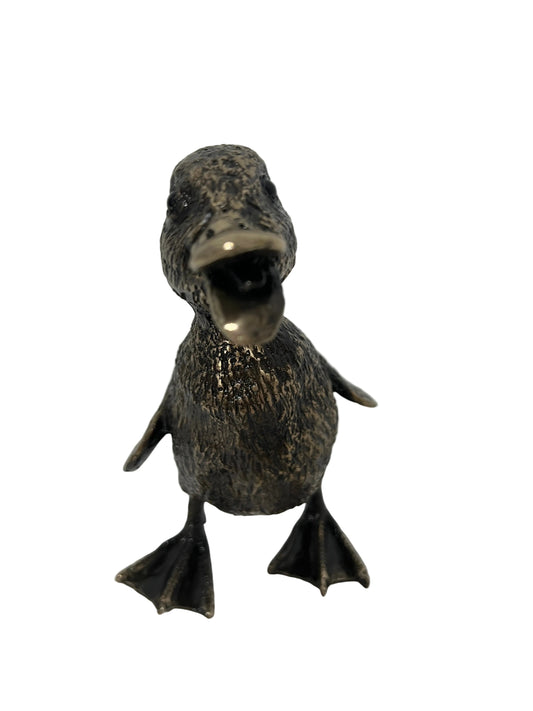 A small duck figurine with an open beak, finished in a textured metallic bronze finish, standing on a white surface against a white background.