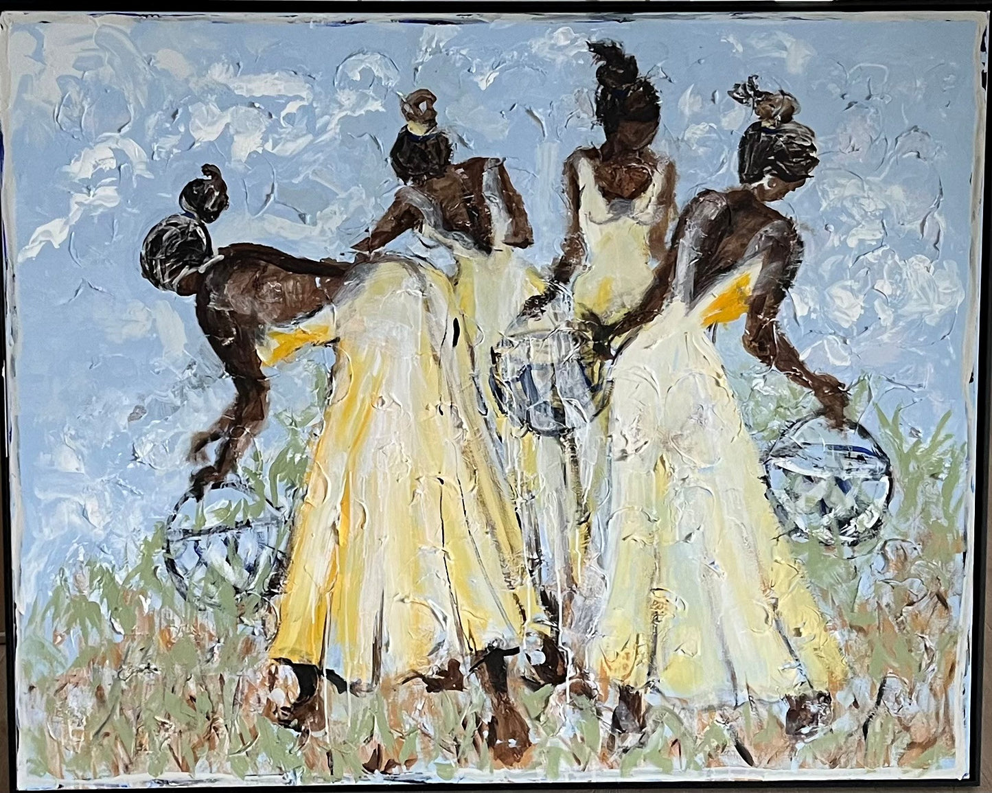 Abstract painting of three figures in yellow dresses with a blue sky and green grass background.