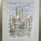 Framed watercolor painting of a cityscape with a prominent cathedral.